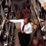 A warehouse containing hundreds of musical instruments for Boston Schools. Murphy Lewis head of musical instruments looks over shelves of instruments.